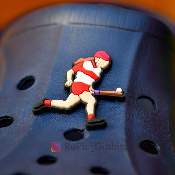 Croc Charm Rupic Gibbitz - Camogie player soloing in red & white kit